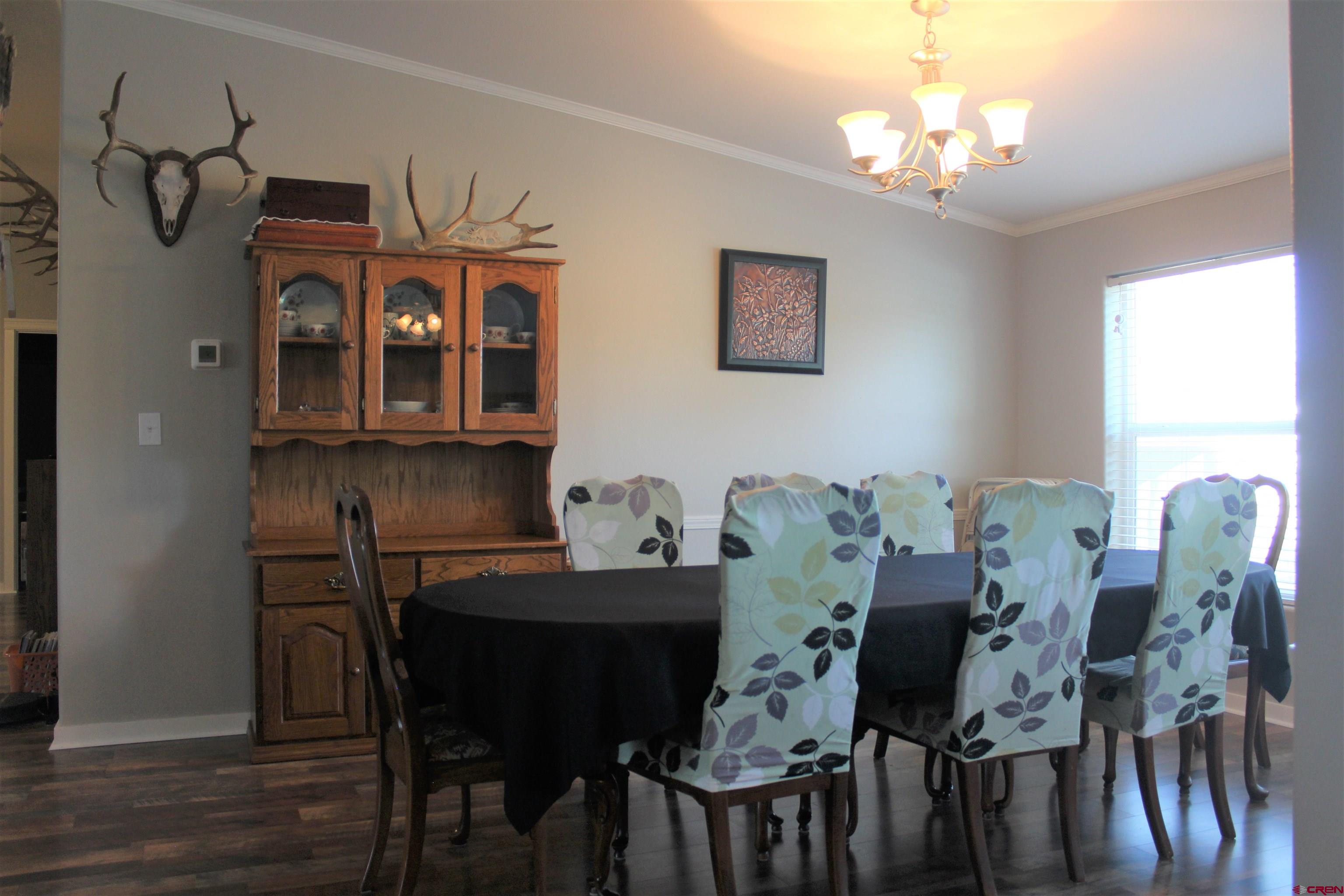 16875 Ember Road Cedaredge, CO 81413 - Photo 11 of 31 a view of a dining room with furniture and chandelier