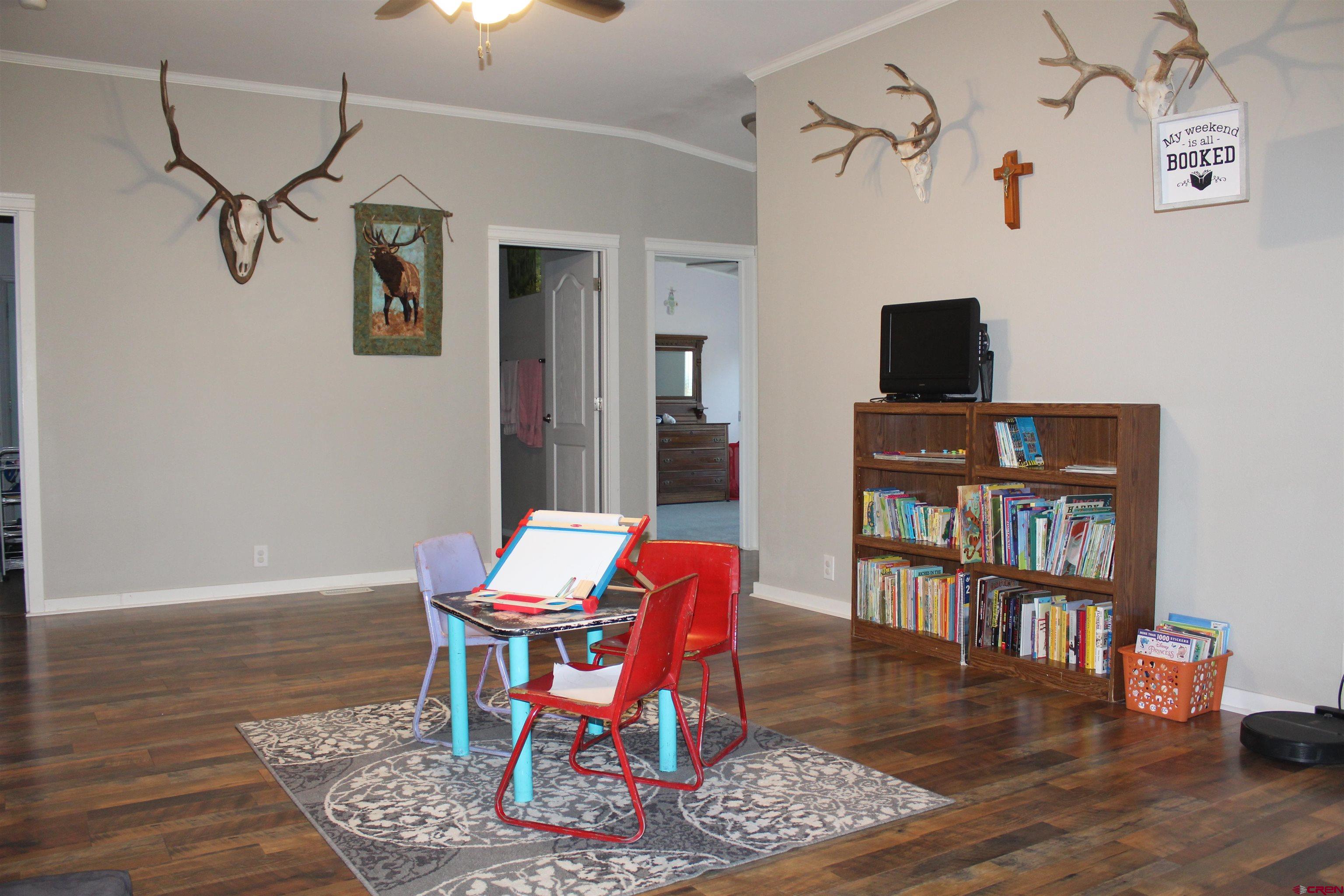 16875 Ember Road Cedaredge, CO 81413 - Photo 20 of 31 a living room with furniture and a wooden floor