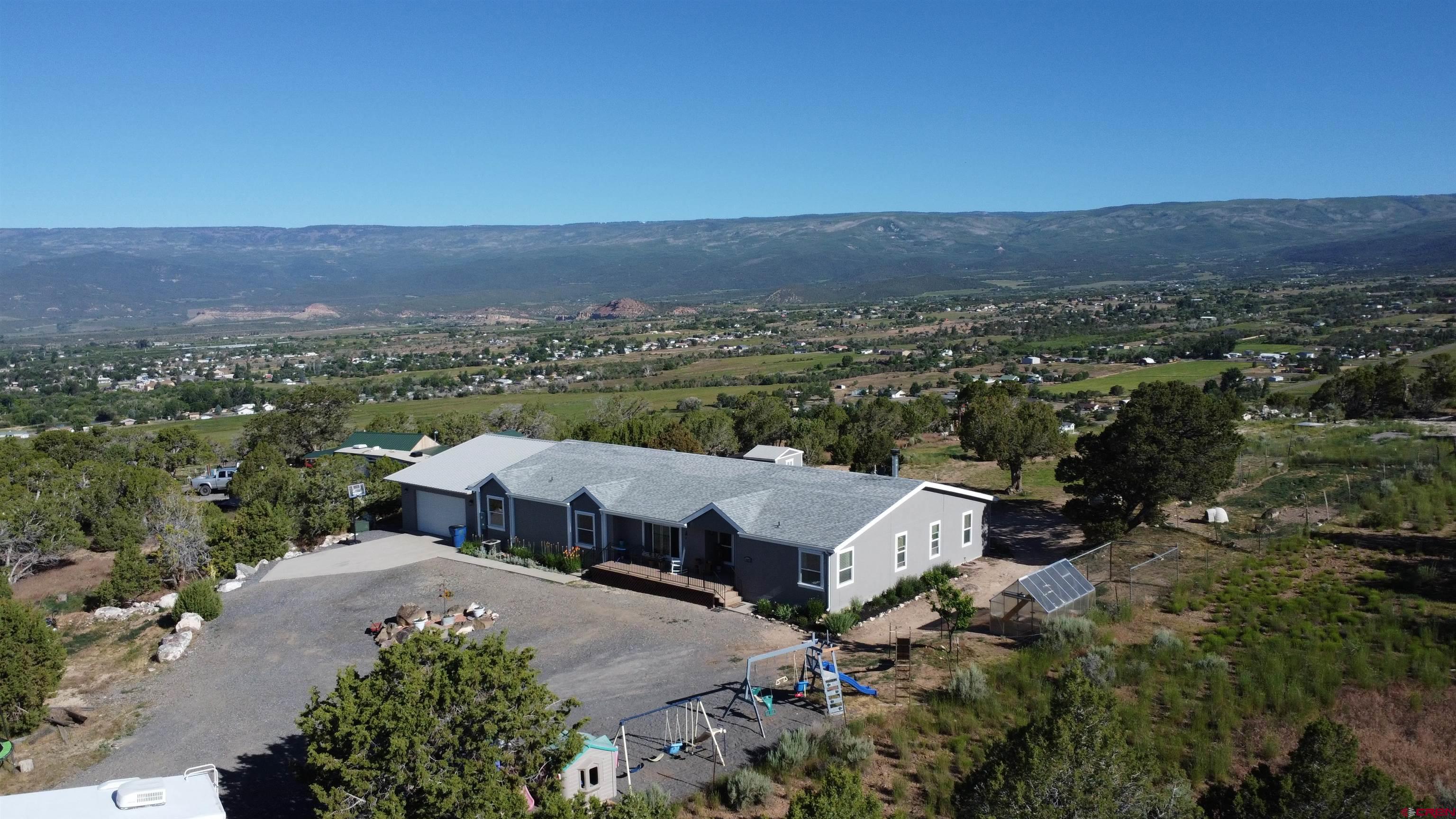 16875 Ember Road Cedaredge, CO 81413 - Photo 2 of 31 an aerial view of a house with a garden