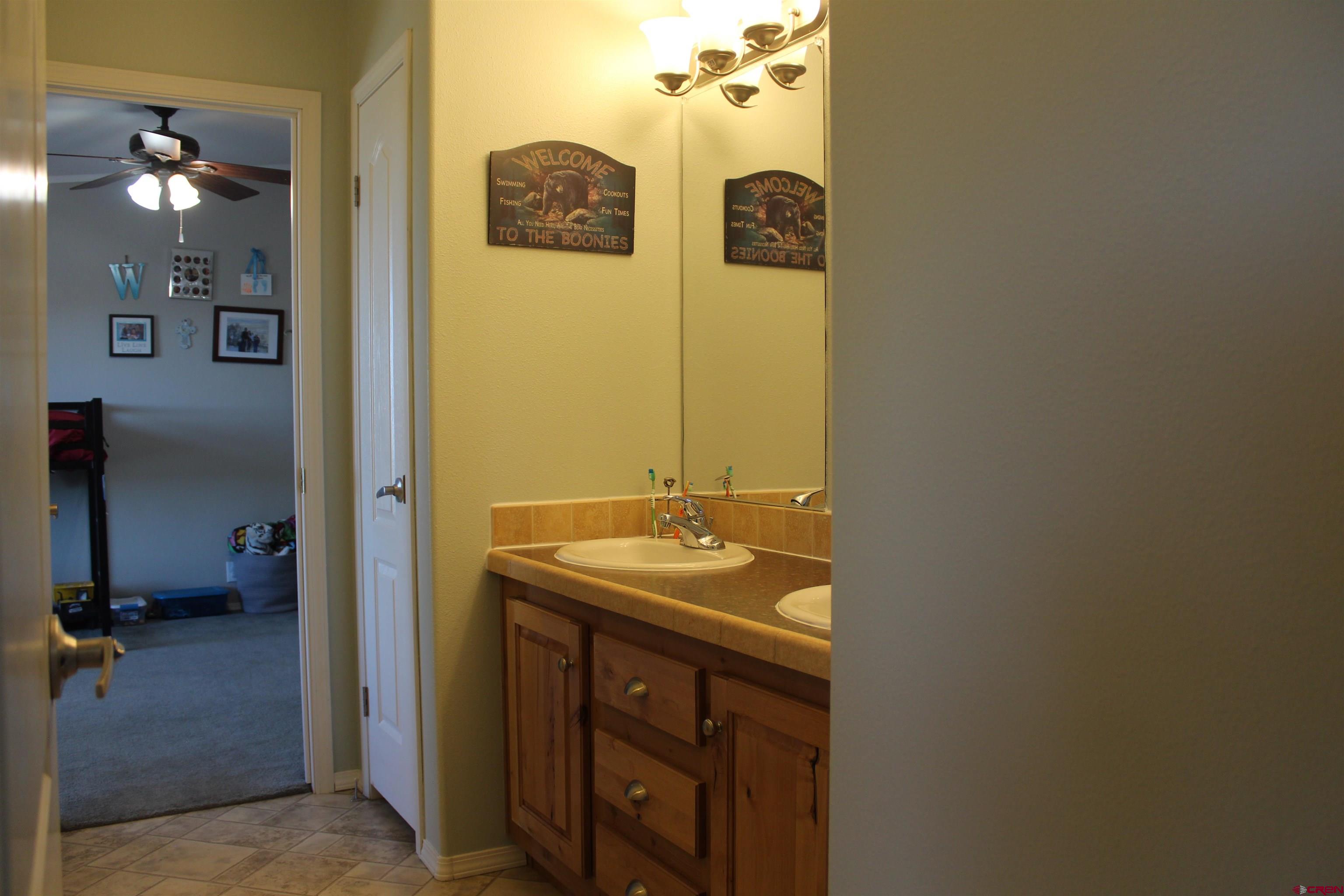 16875 Ember Road Cedaredge, CO 81413 - Photo 25 of 31 a bathroom with a sink and a mirror