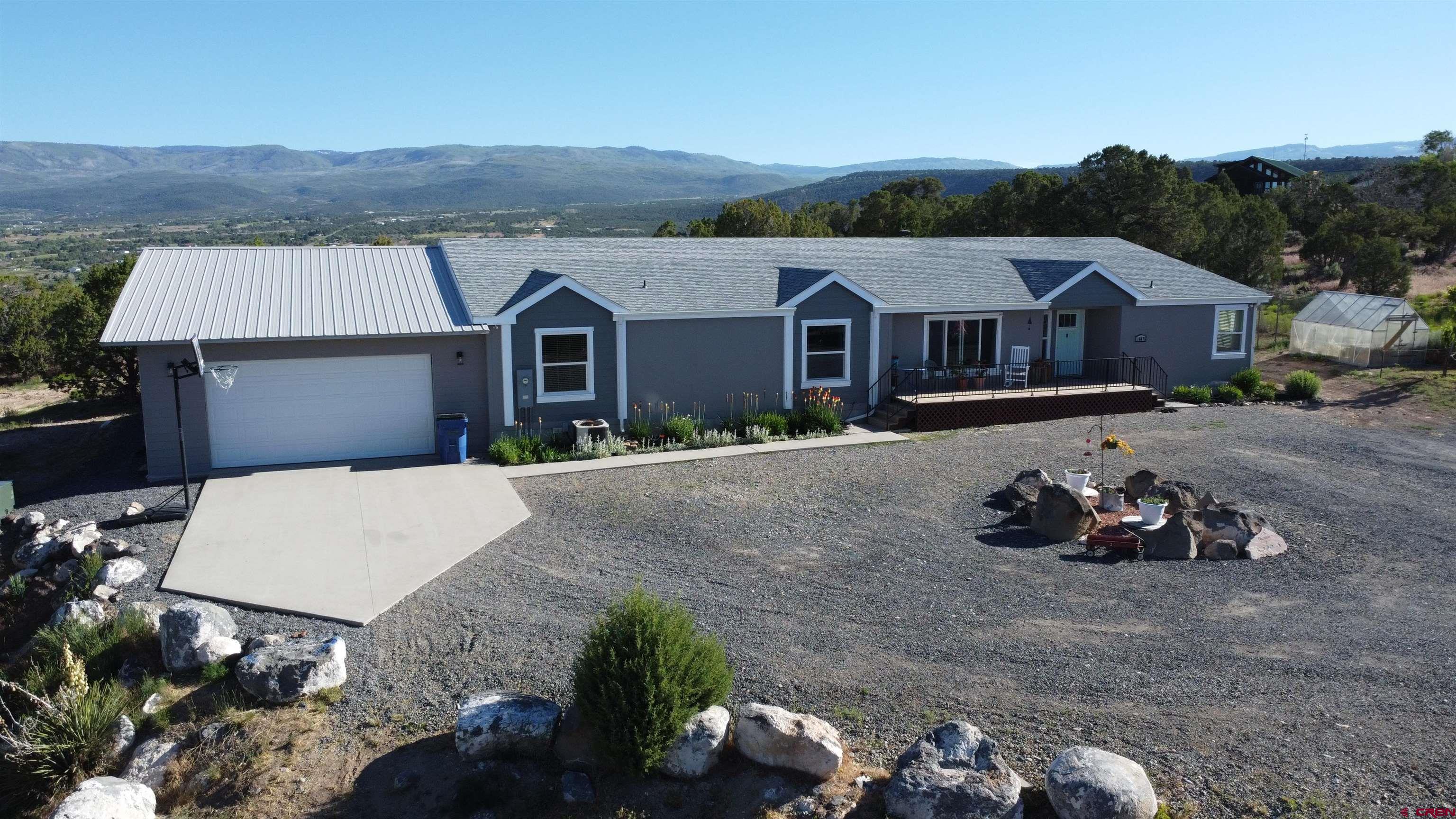 16875 Ember Road Cedaredge, CO 81413 - Photo 3 of 31 a view of a house with a yard and sitting area