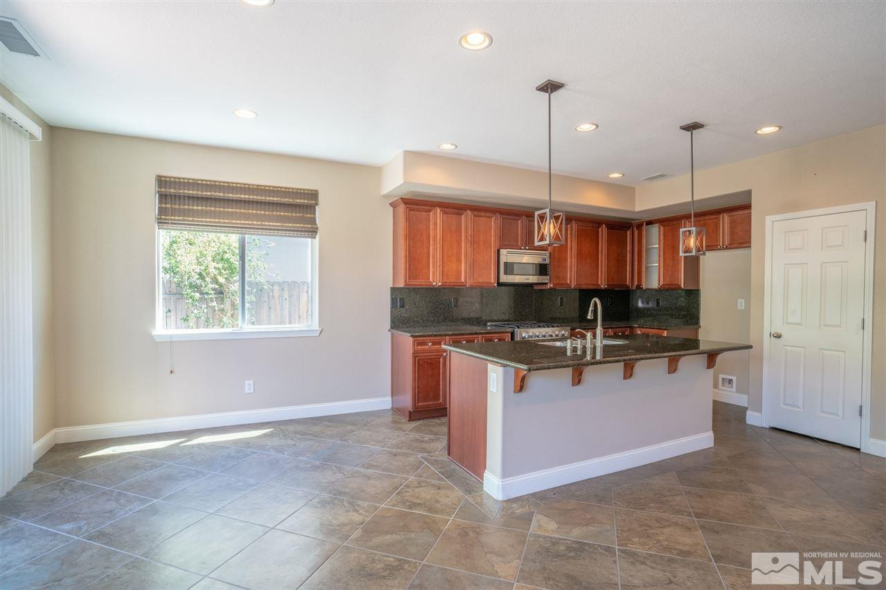 1975 Long Reno, NV 89521 - Photo 11 of 23 a kitchen with stainless steel appliances granite countertop a stove and a sink