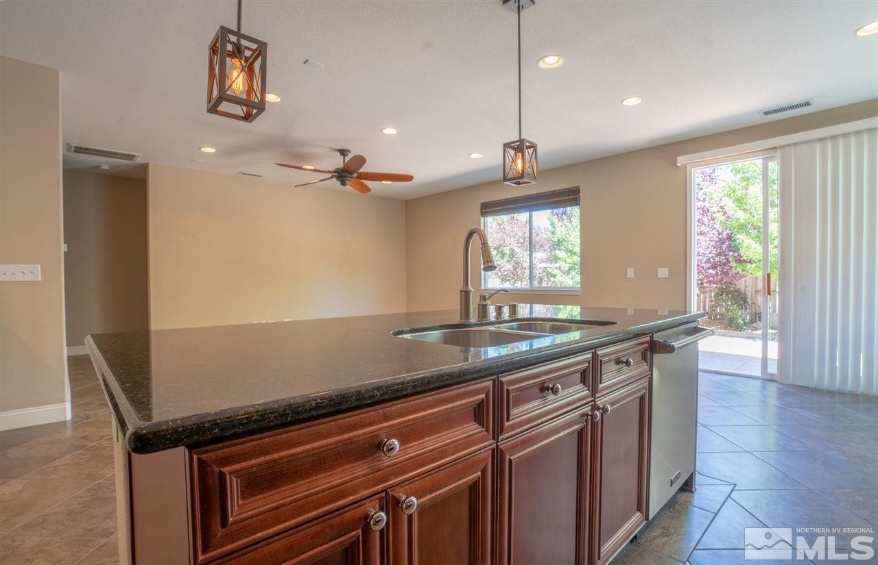 1975 Long Reno, NV 89521 - Photo 9 of 23 a kitchen with granite countertop a sink a counter space appliances and windows