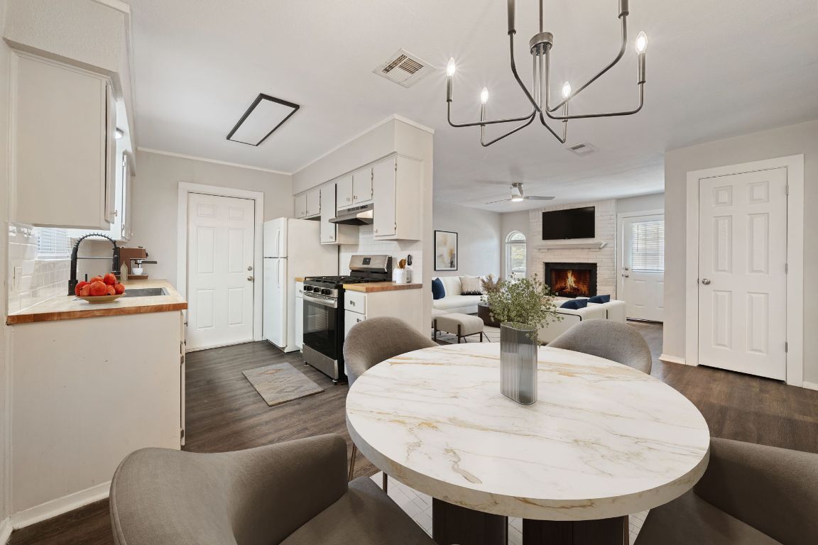 1810 Mearns Meadow Boulevard, Unit A Austin, TX 78758 - Photo 5 of 16 a living room with fireplace furniture and a dining table