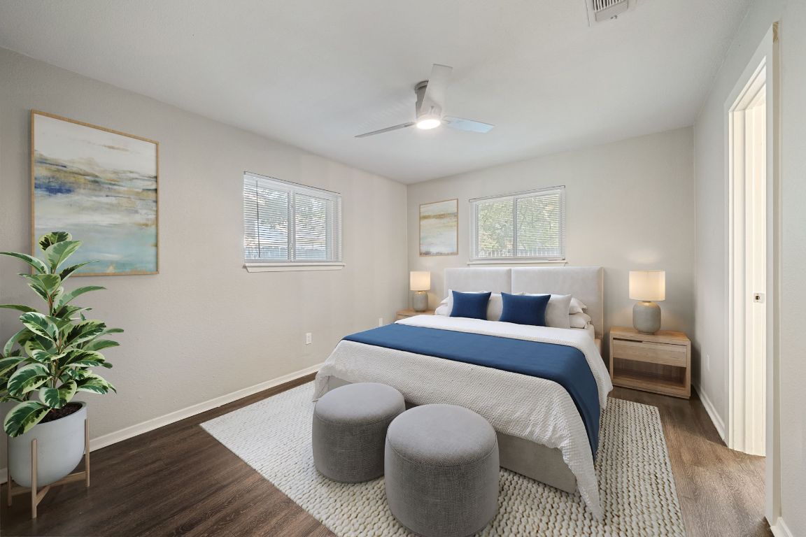 1810 Mearns Meadow Boulevard, Unit A Austin, TX 78758 - Photo 6 of 16 a bedroom with a bed and wooden floor