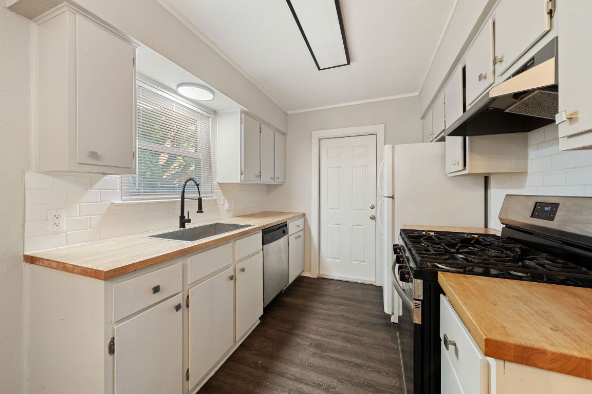 1810 Mearns Meadow Boulevard, Unit A Austin, TX 78758 - Photo 8 of 16 a kitchen with a sink stove and cabinets