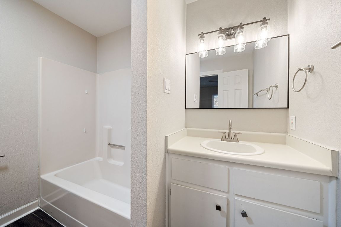 1810 Mearns Meadow Boulevard, Unit A Austin, TX 78758 - Photo 10 of 16 a bathroom with a sink and a mirror