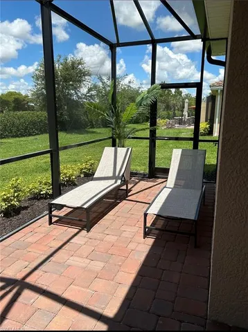 a view of a patio with a table chairs and garden