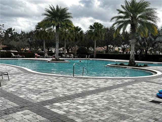 a view of a swimming pool with a garden and trees