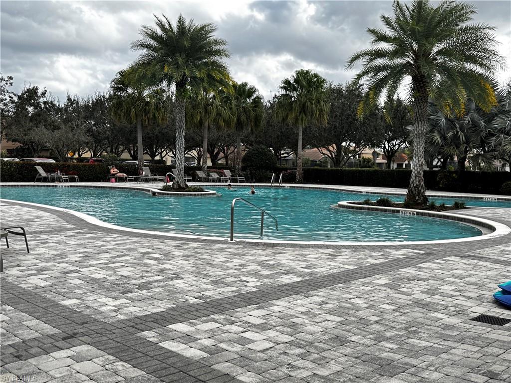 2084 Wellington Street Naples, FL 34120 - Photo 21 of 23 a view of a swimming pool with a garden and trees