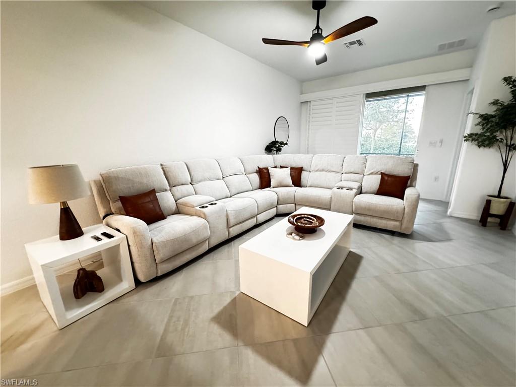 2084 Wellington Street Naples, FL 34120 - Photo 3 of 23 a living room with furniture and a large window