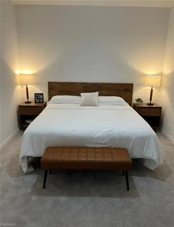 a bedroom with a bed and a lamp