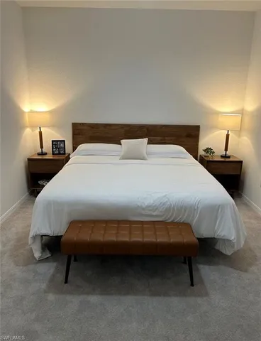a bedroom with a bed and a lamp