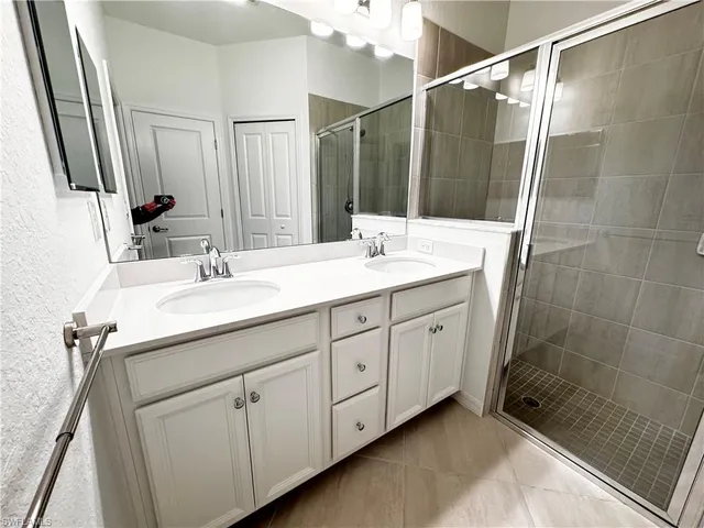 a bathroom with a double vanity sink and mirror