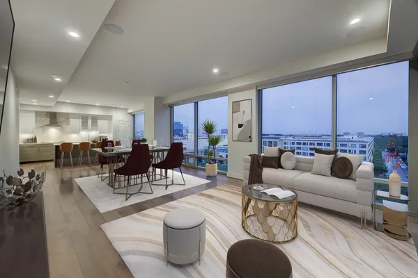 a living room with furniture a rug and a large window