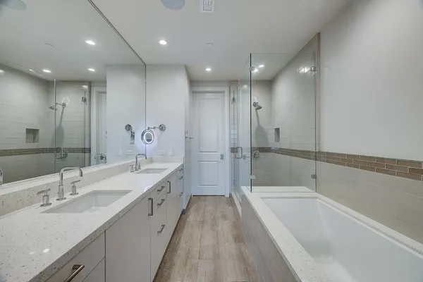 a view of empty room with wooden floor and ceiling fan