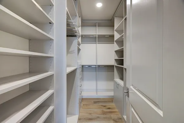 a view of walk in closet with empty racks