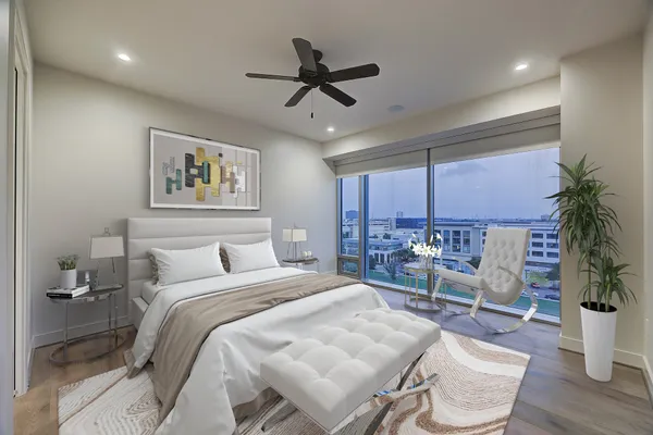 a bedroom with a bed a couch and potted plant with the view