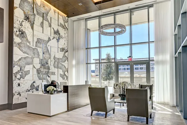 a living room with furniture a fireplace and a large window
