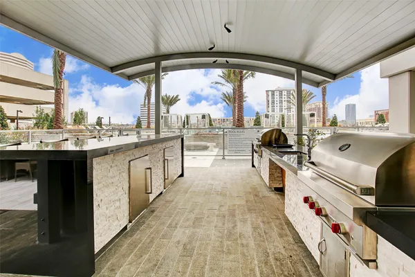 a view of a patio with dining table and chairs with wooden floor and plants