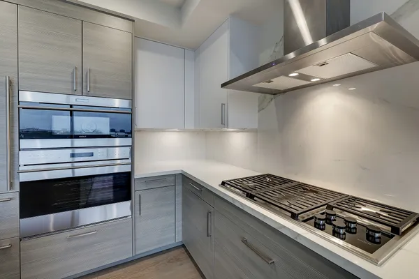 a kitchen with granite countertop cabinets and wooden floor
