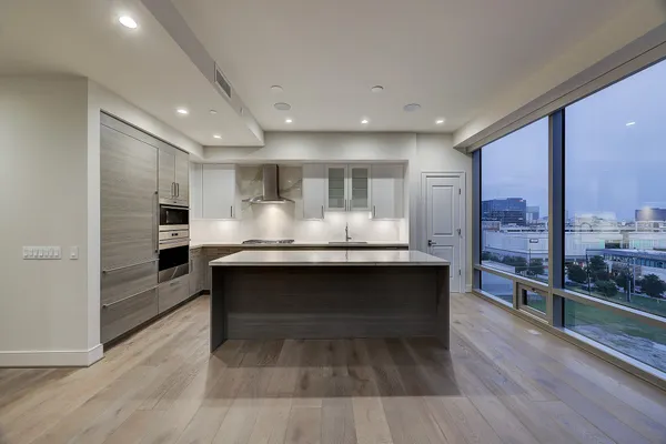 a kitchen with stainless steel appliances granite countertop a sink counter space and wooden floor