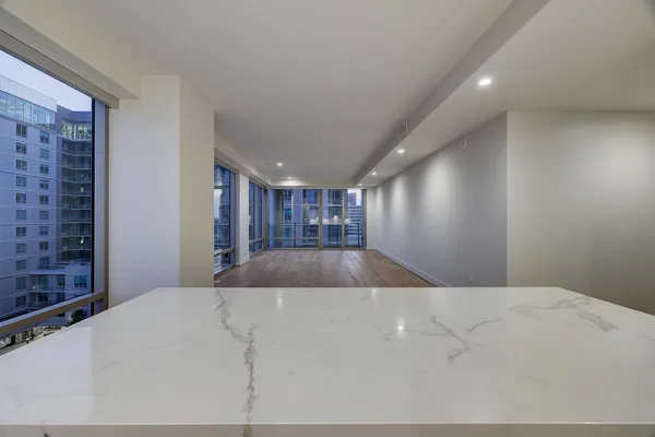 a large kitchen with stainless steel appliances a large counter top