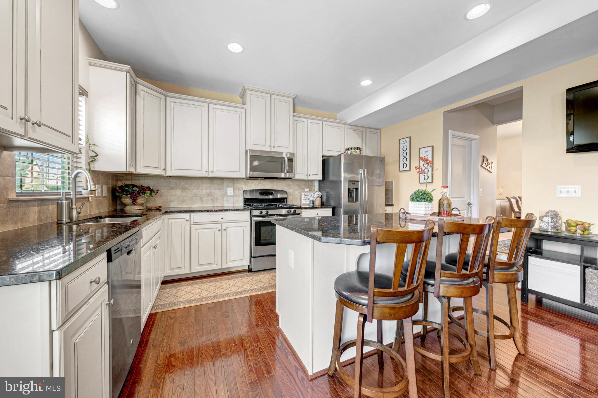 7137 Shepherdstown Road Warrenton, VA 20187 - Photo 20 of 60 a kitchen with a table chairs microwave and cabinets