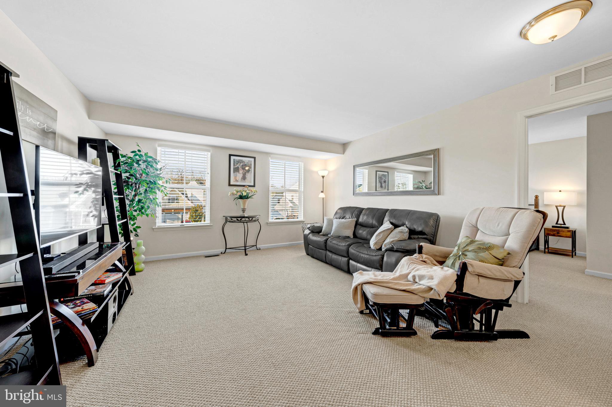 7137 Shepherdstown Road Warrenton, VA 20187 - Photo 25 of 60 a living room with furniture and a flat screen tv
