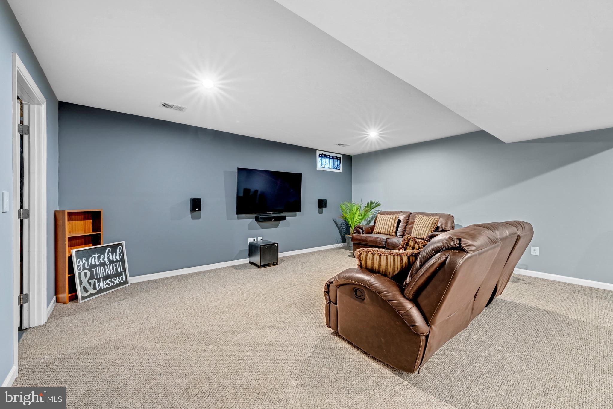 7137 Shepherdstown Road Warrenton, VA 20187 - Photo 41 of 60 a living room with furniture and a flat screen tv