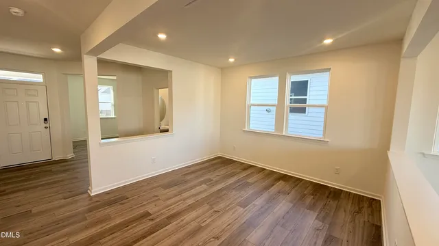 a kitchen with stainless steel appliances a microwave a stove a sink dishwasher a refrigerator and wooden floor