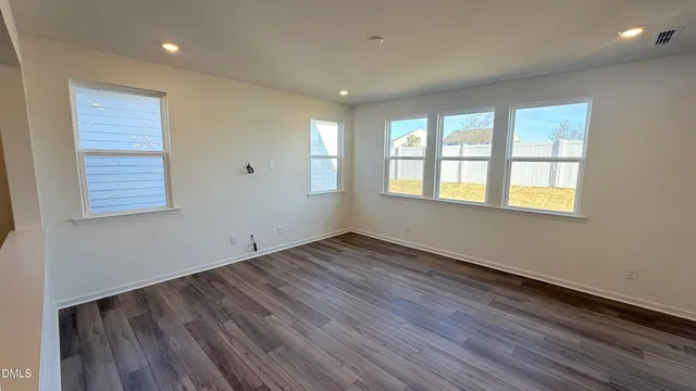 a kitchen with stainless steel appliances a refrigerator a sink a stove a microwave and wooden cabinets