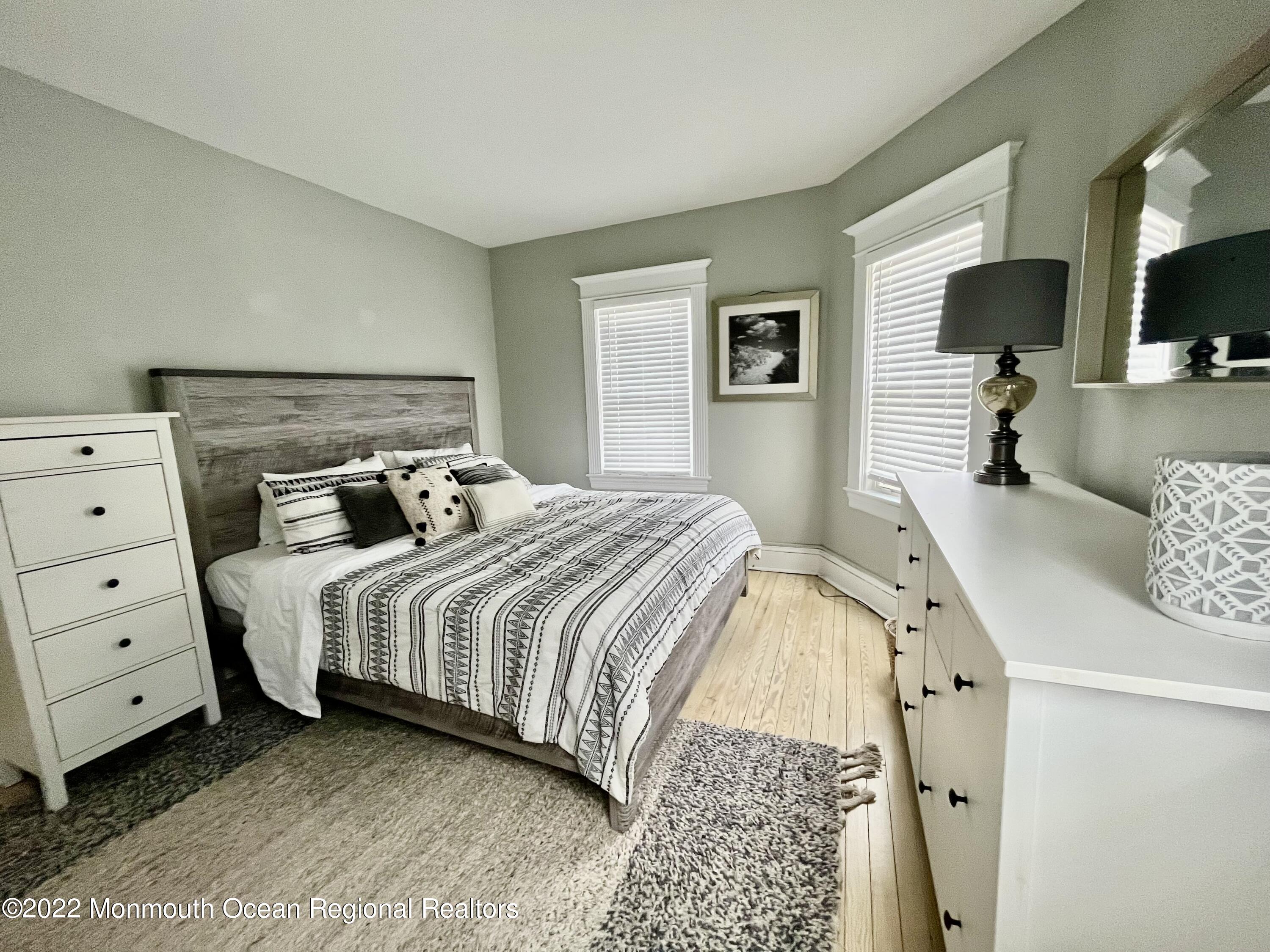 204 4th Avenue Bradley Beach, NJ 07720 - Photo 11 of 24 a bedroom with a bed and flat screen tv