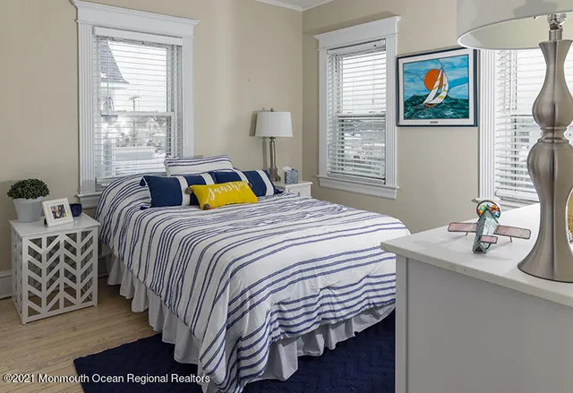 a bedroom with a bed and a painting on the wall