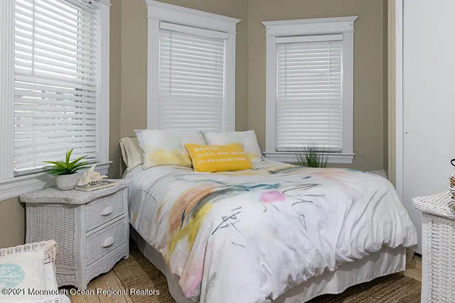 a bedroom with a bed and a potted plant