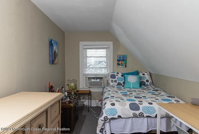 a bedroom with a bed and a table in it