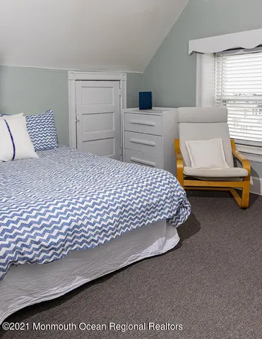 a bedroom with a bed and dresser