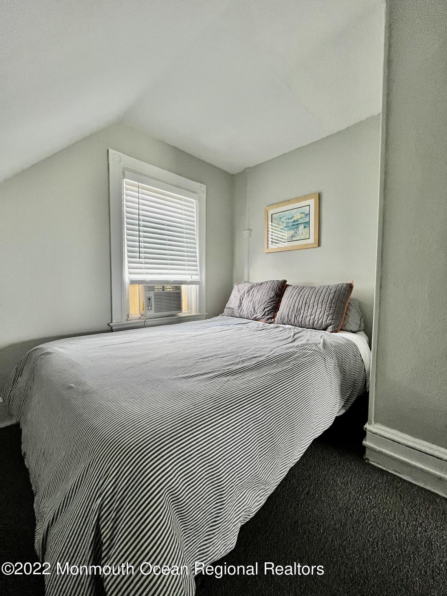 204 4th Avenue Bradley Beach, NJ 07720 - Photo 20 of 24 a bedroom with a bed and a night stand