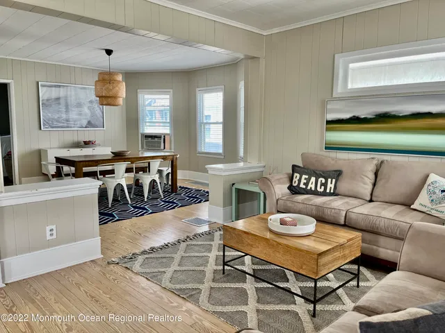 a living room with furniture a dining table and a fireplace