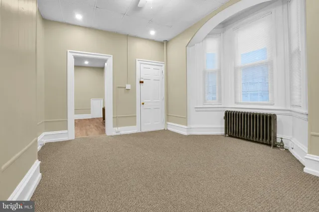 an empty room with wooden floor