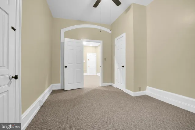 a white toilet sitting next to a bathroom sink and a shower