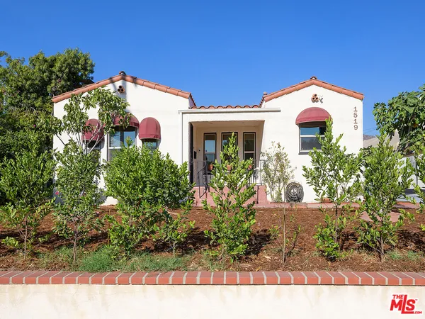 a view of a house with a yard and garden