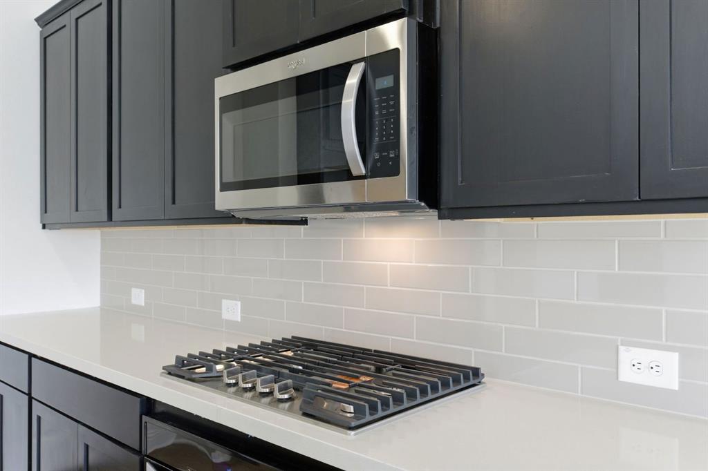 241 Bay Laurel Road McKinney, TX 75071 - Photo 13 of 32 a bathroom with a stove and a microwave