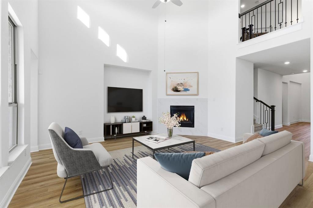 241 Bay Laurel Road McKinney, TX 75071 - Photo 15 of 32 a living room with furniture a flat screen tv and a fireplace