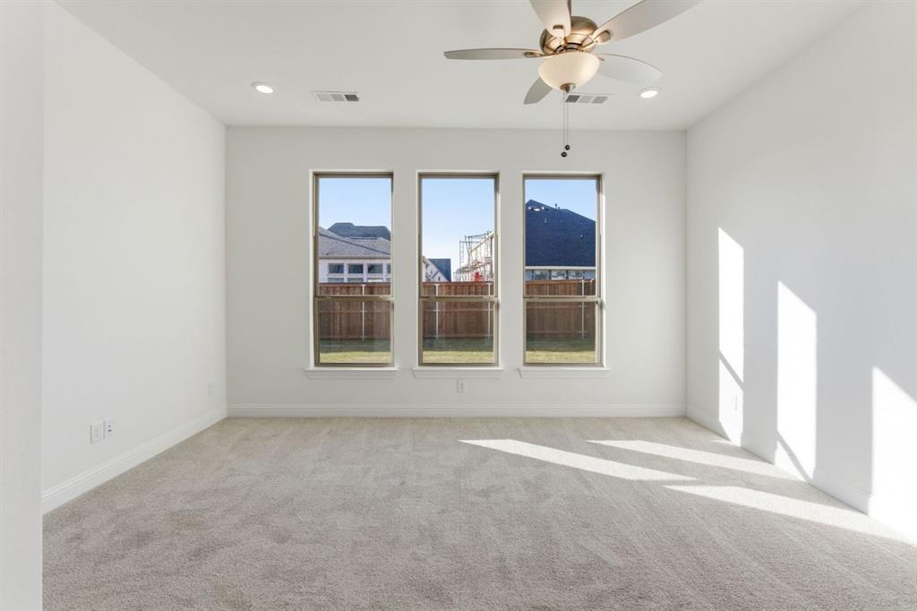 241 Bay Laurel Road McKinney, TX 75071 - Photo 21 of 32 an empty room with chandelier fan and windows