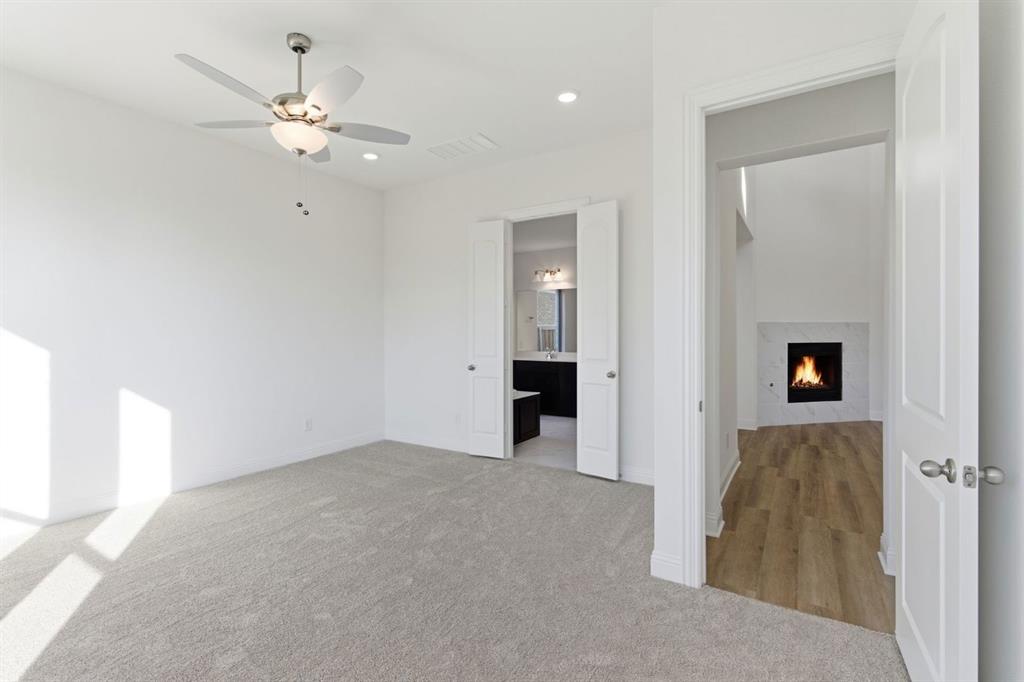 241 Bay Laurel Road McKinney, TX 75071 - Photo 23 of 32 a view of a hallway with a chandelier fan