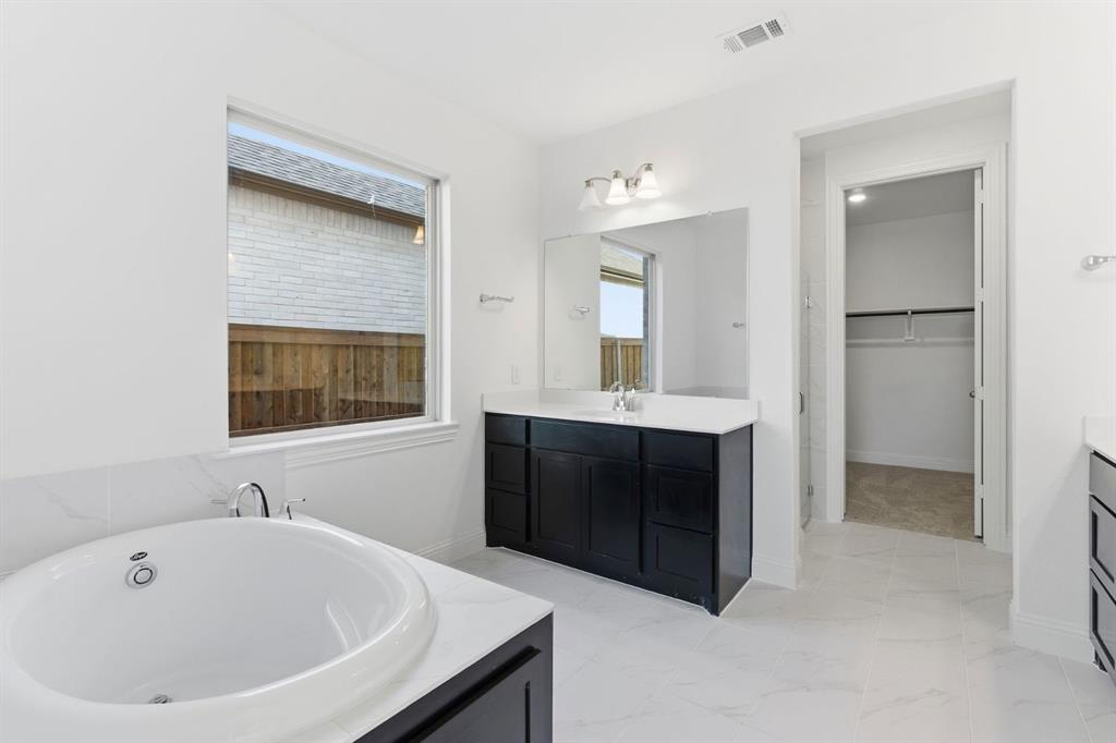 241 Bay Laurel Road McKinney, TX 75071 - Photo 25 of 32 a bathroom with a sink and a mirror