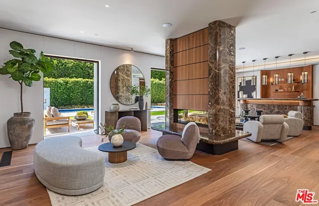a living room with furniture and a floor to ceiling window