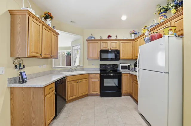 a kitchen with stainless steel appliances a refrigerator sink and microwave