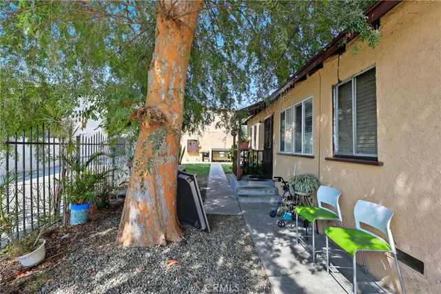 a backyard of a house with table and chairs